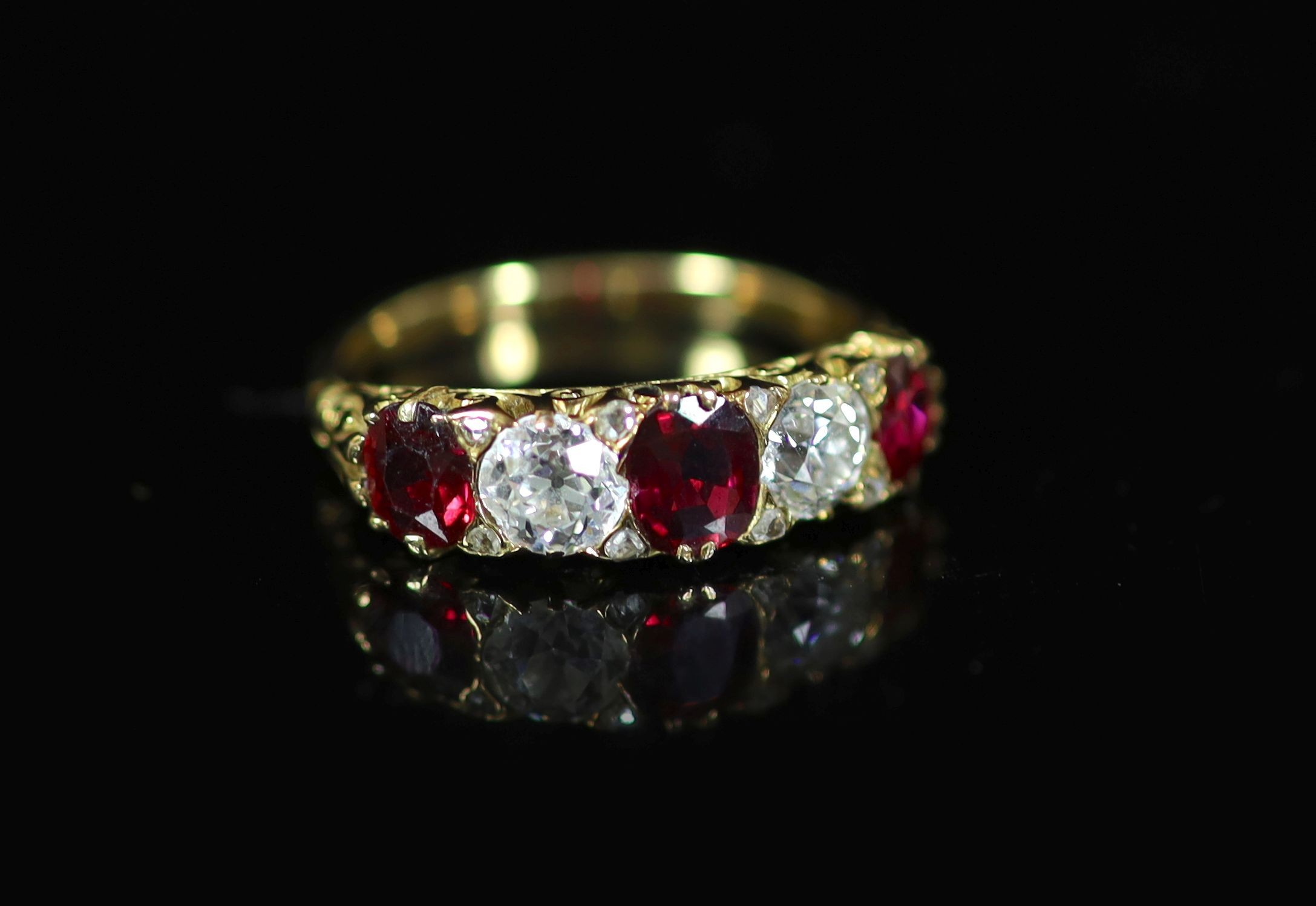 A Victorian style gold, three stone ruby and two stone diamond set half hoop ring